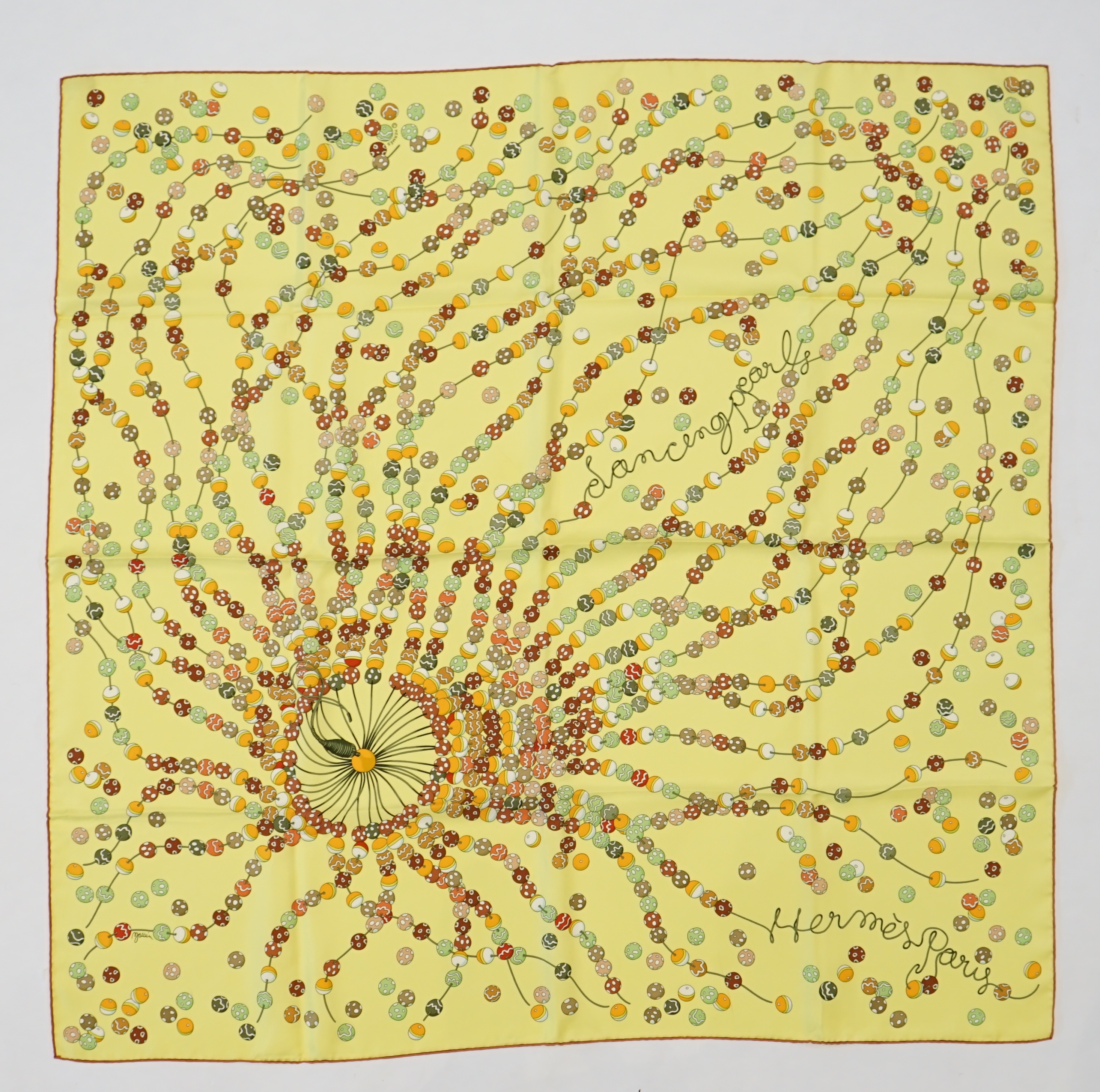 A yellow Hermès 'Dancing Pearls' silk scarf designed by Virginie Jamin, 90cm x 90cm